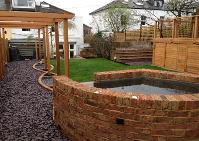 Reclaimed Victorian brick pond and pergola. Family garden brighton