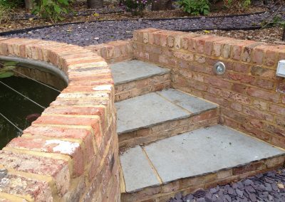 Reclaimed brick pond and slate steps, family garden brighton